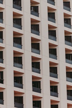 Close-up of a modern apartment building facade in Belém, showcasing geometric windows and balconies.
