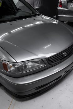 Detailed view of a silver Toyota Corolla parked indoors, showcasing automotive design.